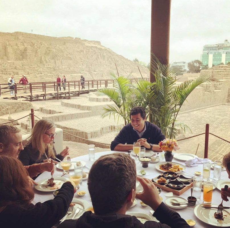 Travelers dining outdoors near Lima's coast
